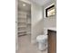 Bathroom featuring a toilet, vanity, and a small walk-in closet with shelves at 2162 S Ash St, Denver, CO 80222