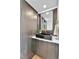 Stylish powder room with textured wall, modern vanity, and elegant gold accents at 2162 S Ash St, Denver, CO 80222