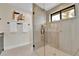 Bathroom with a glass-enclosed shower and modern fixtures; a window brings in natural light at 2162 S Ash St, Denver, CO 80222