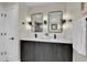 Modern bathroom with a double vanity, dark wood cabinets, white countertops, and rectangular mirrors at 2162 S Ash St, Denver, CO 80222