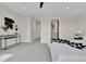 Bright bedroom with carpet and an ensuite bath; view includes an open door to a corridor at 2162 S Ash St, Denver, CO 80222