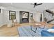 Contemporary living room featuring a sleek fireplace, hardwood floors, and open staircase at 2162 S Ash St, Denver, CO 80222