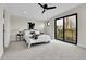 Bright main bedroom featuring a ceiling fan, minimalist decor, and a sliding glass door to a balcony at 2162 S Ash St, Denver, CO 80222