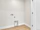 Utility room showcasing hardwood floors with water hookups and outlets at 2162 S Ash St, Denver, CO 80222