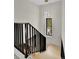 Modern staircase with sleek black railings and a contemporary light fixture at 2162 S Ash St, Denver, CO 80222