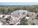 Aerial view of a home with a large deck surrounded by mature trees at 18720 Lake Dr, Monument, CO 80132