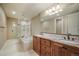 Bathroom featuring a soaking tub, walk-in shower, double vanity, and granite countertops at 18720 Lake Dr, Monument, CO 80132