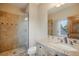 Bathroom with granite countertops, vanity, walk-in shower, and rustic wood door at 18720 Lake Dr, Monument, CO 80132