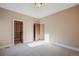 Bedroom featuring carpet flooring, neutral paint, wood doors and trim, and ample space at 18720 Lake Dr, Monument, CO 80132