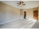 Bedroom with neutral walls, carpet floors, wood door, and a ceiling fan at 18720 Lake Dr, Monument, CO 80132