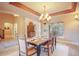 Lovely dining space with travertine floors, coffered ceilings, chandelier and entry archway at 18720 Lake Dr, Monument, CO 80132