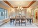 Warm dining room featuring custom tray ceiling, designer lighting, and a large window at 18720 Lake Dr, Monument, CO 80132