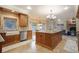 Open kitchen featuring custom wood cabinets, granite countertops, travertine floors, and adjacent breakfast nook at 18720 Lake Dr, Monument, CO 80132