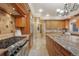 Spacious kitchen featuring custom wood cabinets, granite countertops, and stainless steel appliances at 18720 Lake Dr, Monument, CO 80132