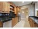 View of a kitchen with custom wood cabinets, stainless steel appliances, and granite countertops at 18720 Lake Dr, Monument, CO 80132