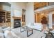 Living room featuring a fireplace, built-in cabinets, and an arched entrance at 18720 Lake Dr, Monument, CO 80132