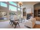 Bright living room with large windows, a fireplace, and built-in shelving at 18720 Lake Dr, Monument, CO 80132