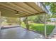 Cozy back porch with covered area, overlooking the green backyard and mature trees at 1140 S Xavier St, Denver, CO 80219