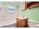 Bathroom features a shower and tub, mirrored cabinet, and wood vanity at 1140 S Xavier St, Denver, CO 80219