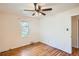 Bedroom with wood floor, ceiling fan, window, and white walls at 1140 S Xavier St, Denver, CO 80219