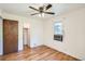 Bedroom features wood floor, ceiling fan, a window, and a closet at 1140 S Xavier St, Denver, CO 80219