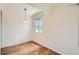 This room features beautiful hardwood floors, an overhead light, and a window at 1140 S Xavier St, Denver, CO 80219