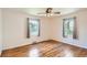 This spacious bedroom features hardwood floors, a ceiling fan, and neutral walls at 1140 S Xavier St, Denver, CO 80219