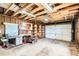 Garage interior with workbench, shelves, and unfinished walls at 1140 S Xavier St, Denver, CO 80219