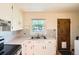 This modest kitchen features a stainless sink, white cabinets, and linoleum flooring at 1140 S Xavier St, Denver, CO 80219