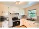 A well-lit kitchen with double sinks, cabinets, and updated oven at 1140 S Xavier St, Denver, CO 80219