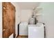 Laundry room with washer, dryer, water heater, and shelving at 1140 S Xavier St, Denver, CO 80219