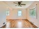 Bright living room featuring hardwood floors, ceiling fan, and natural light at 1140 S Xavier St, Denver, CO 80219