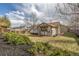 Backyard view with manicured shrubs and wood fence surrounding a quaint home at 965 W 96Th Ave, Thornton, CO 80260