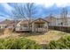 Well-maintained backyard with manicured landscaping, deck, and wood fence at 965 W 96Th Ave, Thornton, CO 80260
