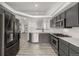 Modern kitchen featuring stainless steel appliances, gray cabinetry and white subway tile backsplash at 965 W 96Th Ave, Thornton, CO 80260
