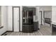 This kitchen shows modern appliances, white walls, gray cabinets and an adjacent staircase at 965 W 96Th Ave, Thornton, CO 80260