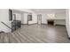 A spacious living room featuring new flooring, fireplace with white wall color, and a staircase at 965 W 96Th Ave, Thornton, CO 80260