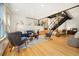 Bright living room with hardwood floors, recessed lighting, modern decor, and staircase at 2937 Champa St # A, Denver, CO 80205