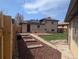 Backyard featuring a lawn, garden beds, wood deck, and a privacy fence at 3530 Dahlia St, Denver, CO 80207