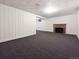 Finished basement with ample space, plush carpeting, and a classic fireplace at 3530 Dahlia St, Denver, CO 80207