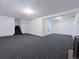 Large basement space with carpeting and access to the laundry area and staircase at 3530 Dahlia St, Denver, CO 80207
