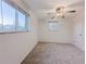 Simple bedroom featuring carpeted floors, neutral walls, and a ceiling fan at 3530 Dahlia St, Denver, CO 80207