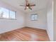 Bright bedroom with hardwood floors, a ceiling fan, and large windows, creating a relaxing retreat at 3530 Dahlia St, Denver, CO 80207