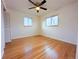 Bright bedroom with wood floors, a ceiling fan, and natural light from the windows at 3530 Dahlia St, Denver, CO 80207