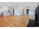 Spacious living room boasts gleaming hardwood floors, a modern ceiling fan, and a cozy fireplace at 3530 Dahlia St, Denver, CO 80207