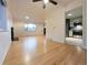 Bright living room showcasing hardwood floors, a fireplace, and an open layout with seamless access to the kitchen at 3530 Dahlia St, Denver, CO 80207