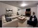 A cozy living room featuring a plush sofa, modern furniture, and a classic fireplace at 3530 Dahlia St, Denver, CO 80207