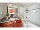 Cozy bathroom featuring a tiled shower/tub combo, white vanity, and neutral accents at 3195 Blake St # 106, Denver, CO 80205