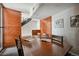 Spacious dining room with a long wooden table, a staircase, and modern artwork at 3195 Blake St # 106, Denver, CO 80205