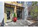 Inviting entrance with a green door, potted plants, and a small outdoor patio area at 3195 Blake St # 106, Denver, CO 80205